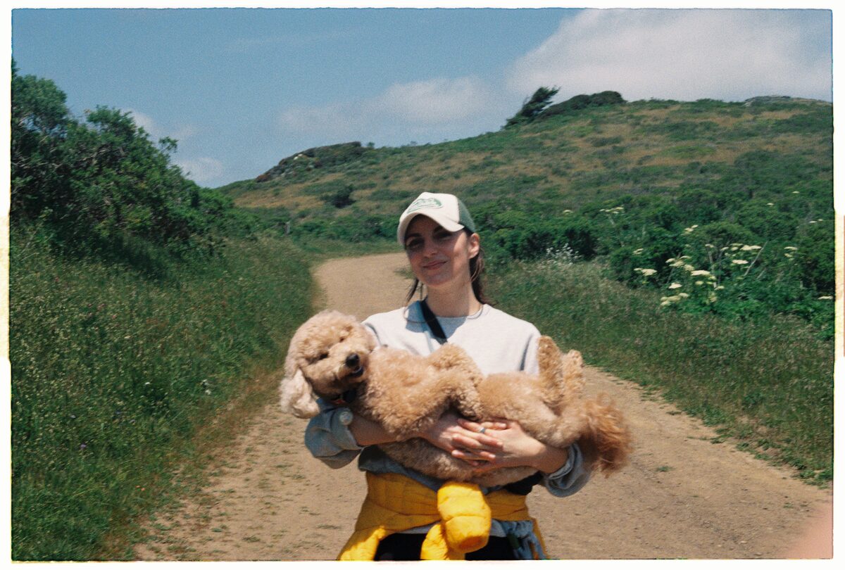 Beryl carrying Brock on trail