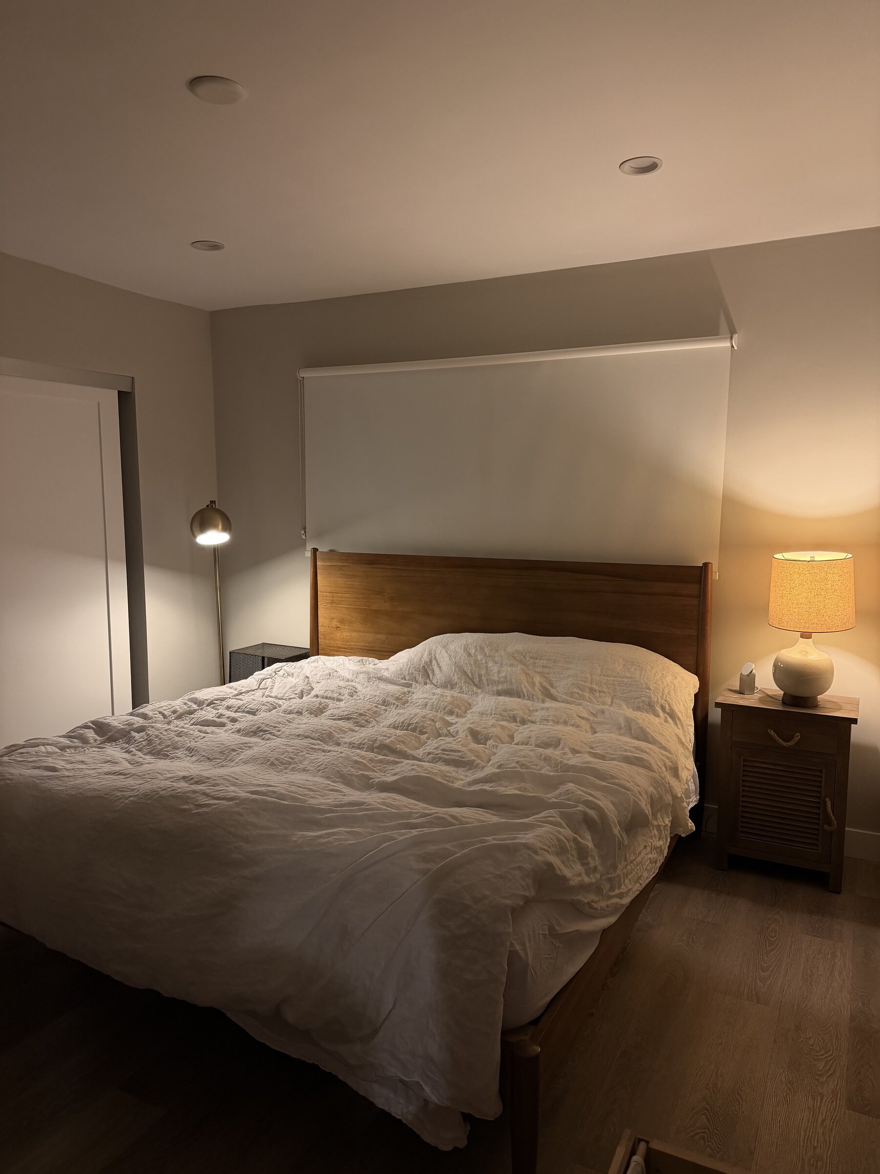 Bedroom with warm lighting and linen bedding